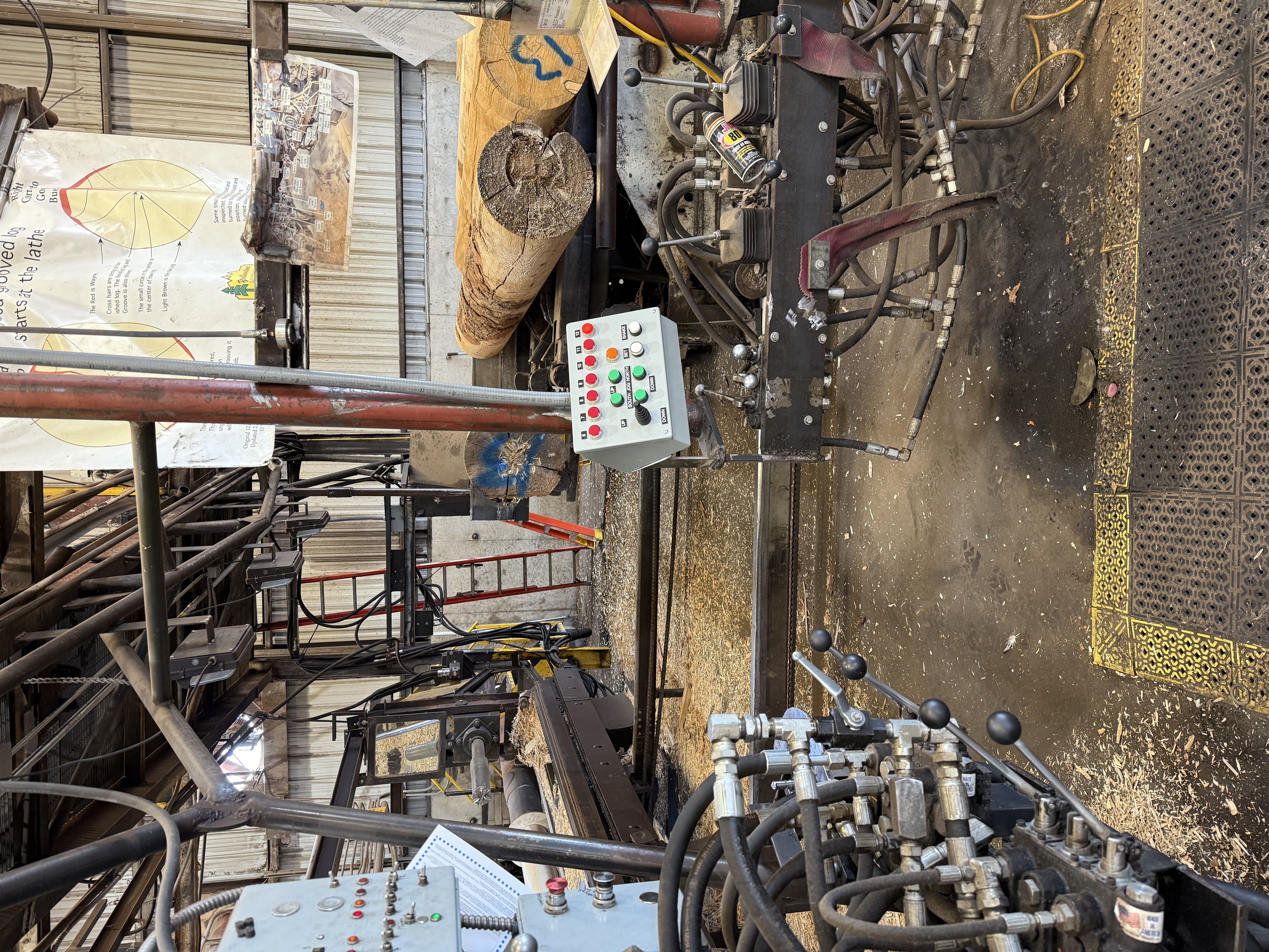 Industrial log lathe with custom controls in a sawmill